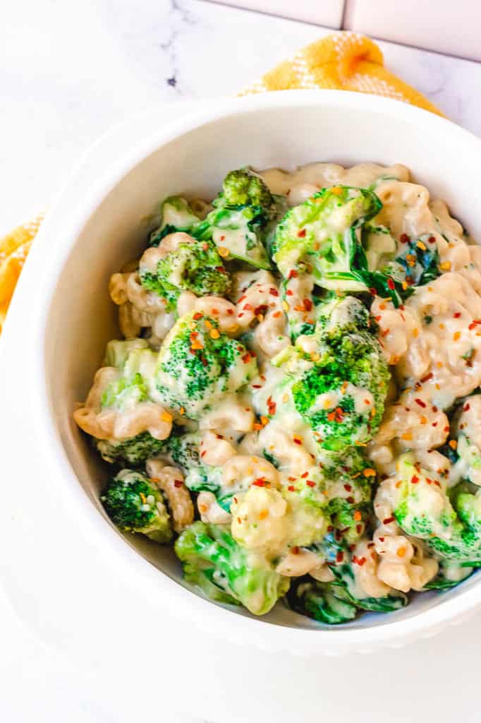 healthy mac and cheese with broccoli served in a white bowl