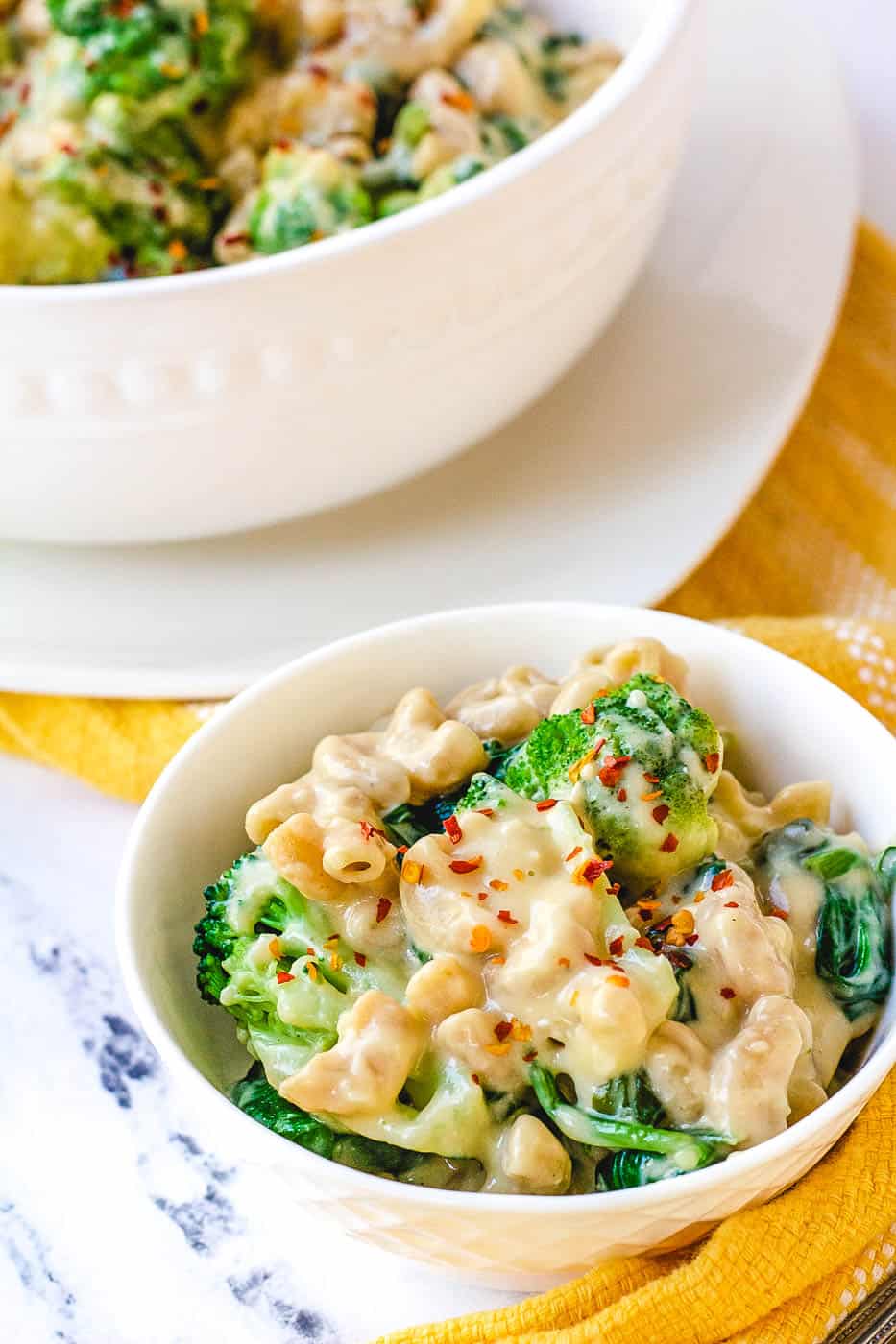 healthy mac and cheese with broccoli served in a white bowl