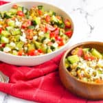 feta salad with lentils, cucumbers, tomatoes, corn in a bowl