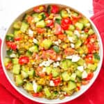 feta salad with lentils, cucumbers, tomatoes, corn in a bowl
