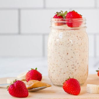 peanut butter overnight oats in a mason jar with strawberries and bananas