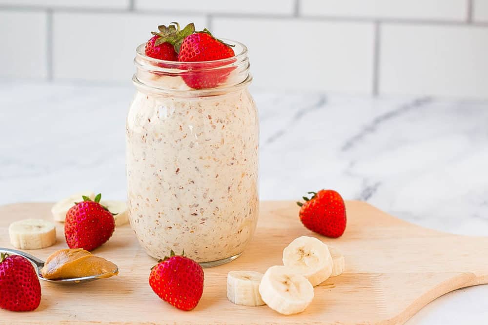 peanut butter oats in a mason jar with strawberries and bananas