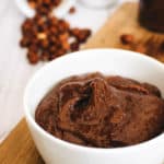 vegan nutella with hazelnuts and dark chocolate, served on a wooden cutting board