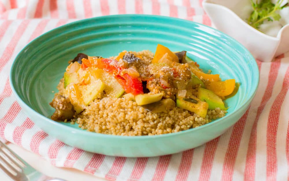 vegan ratatouille with seasonal vegetables in a blue bowl