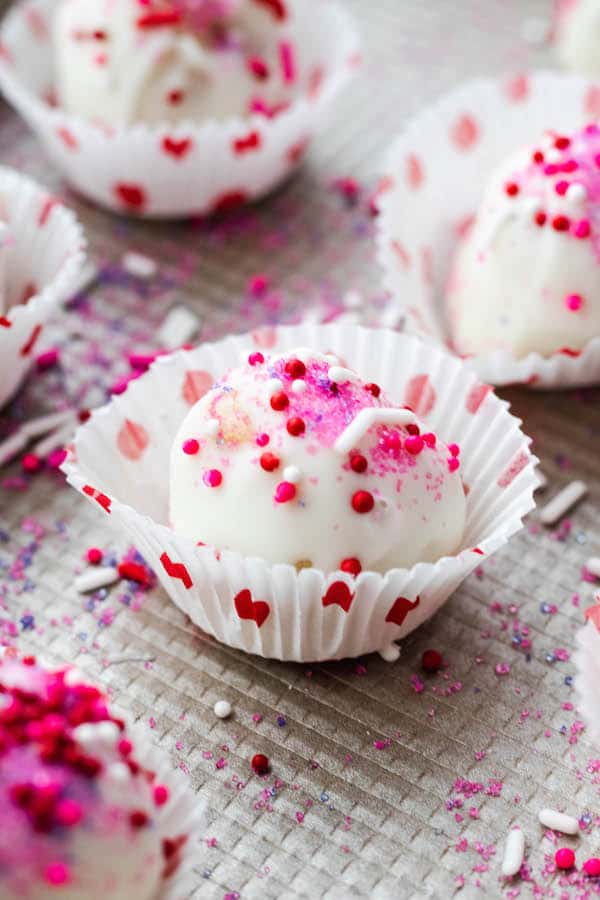 sugar cookie bites in heart cups and red and pink sprinkles