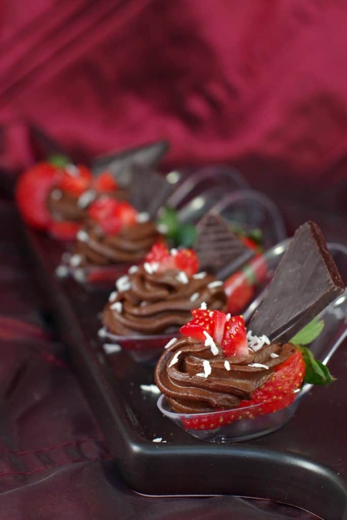 strawberries filled with avocado mousse and a wedge of chocolate