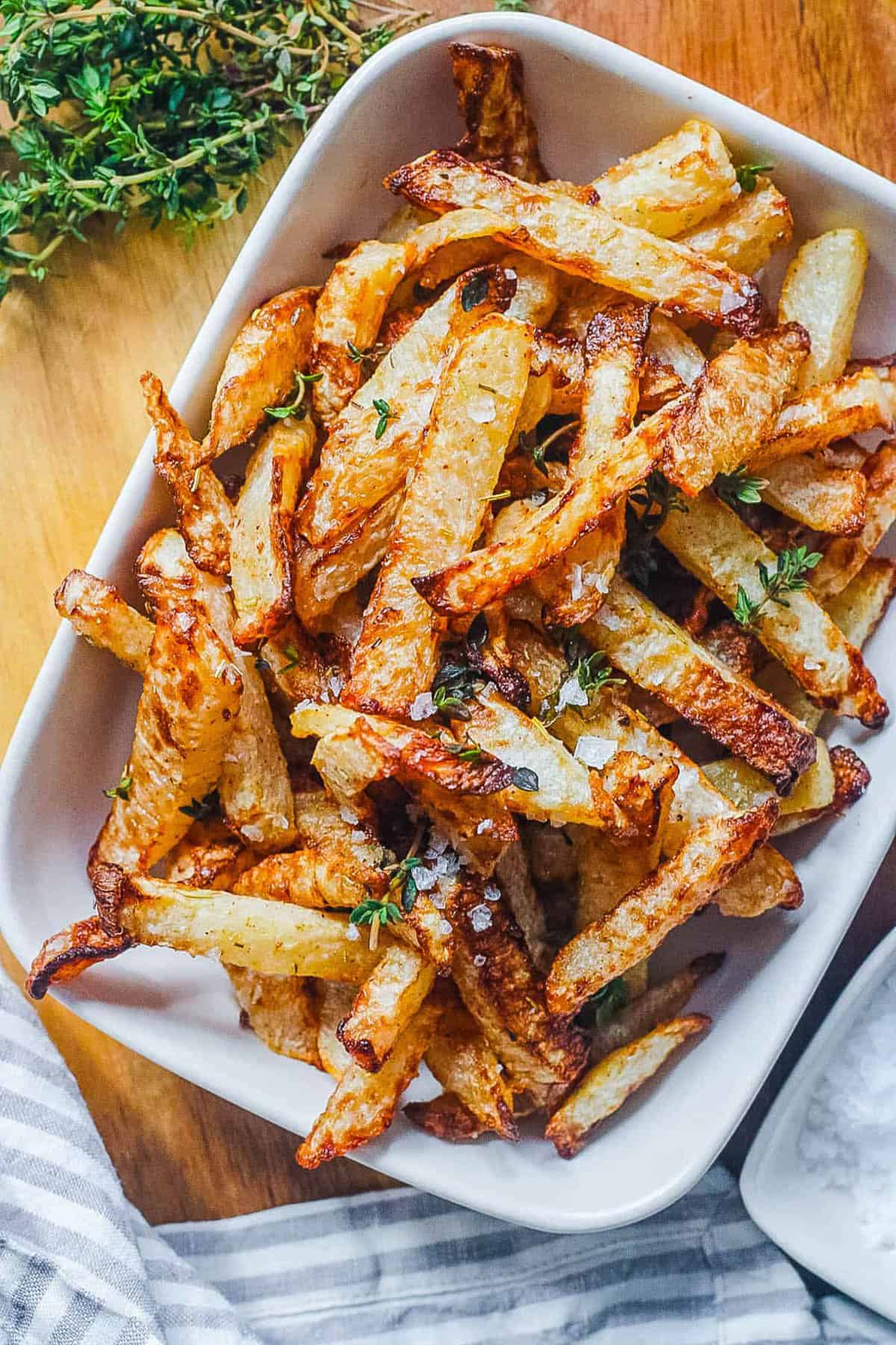 Air fryer jicama fries, served on a white serving platter.