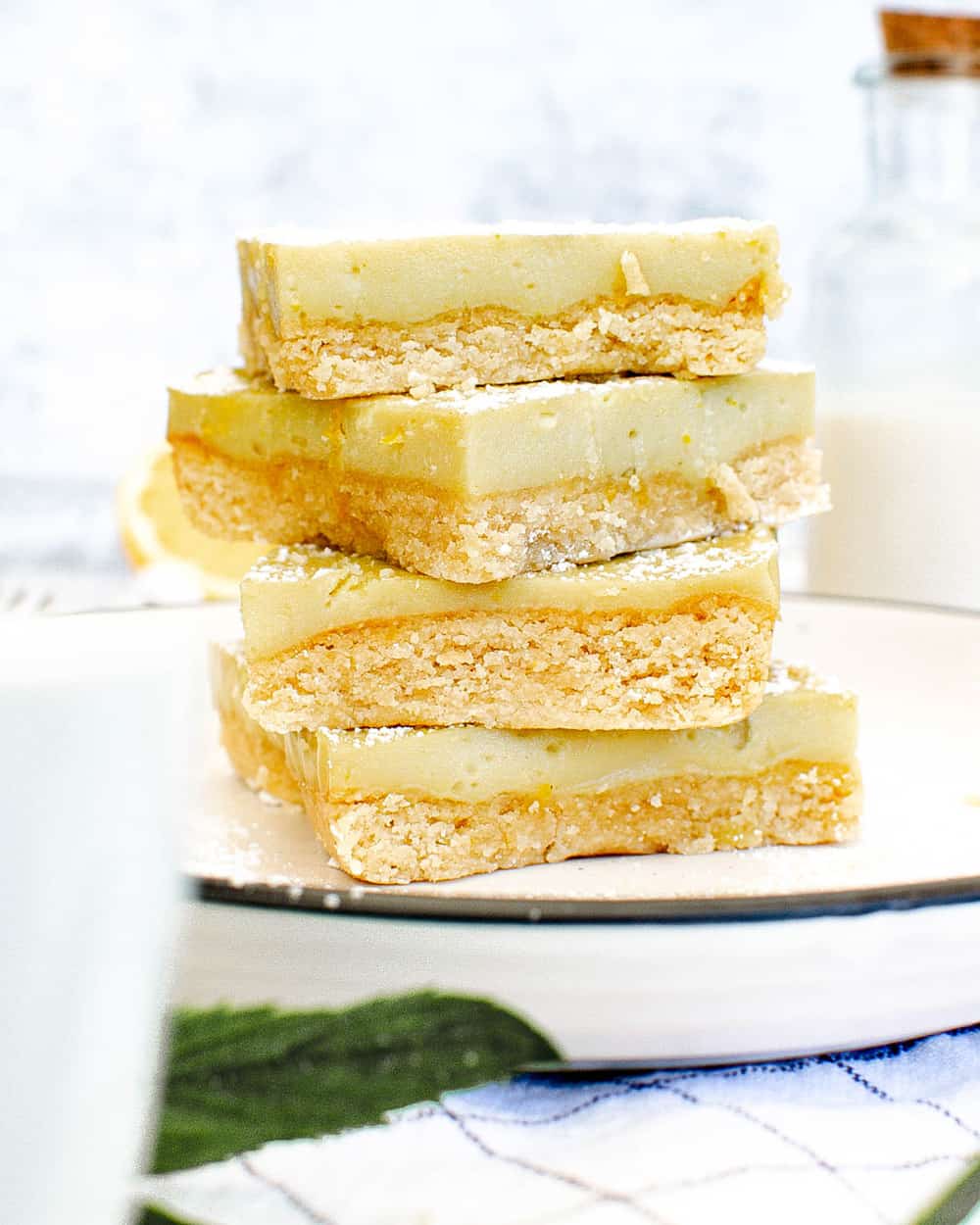 vegan gluten free lemon bars stacked on a white plate