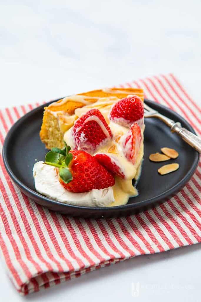 strawberry flan on black plate and striped kitchen towel - romantic desserts for two