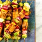 finished tofu skewers on a blue plate