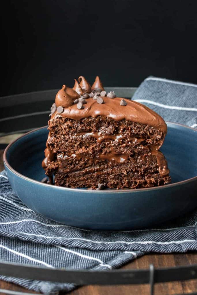 layered chocolate zucchini cake in a blue bowl