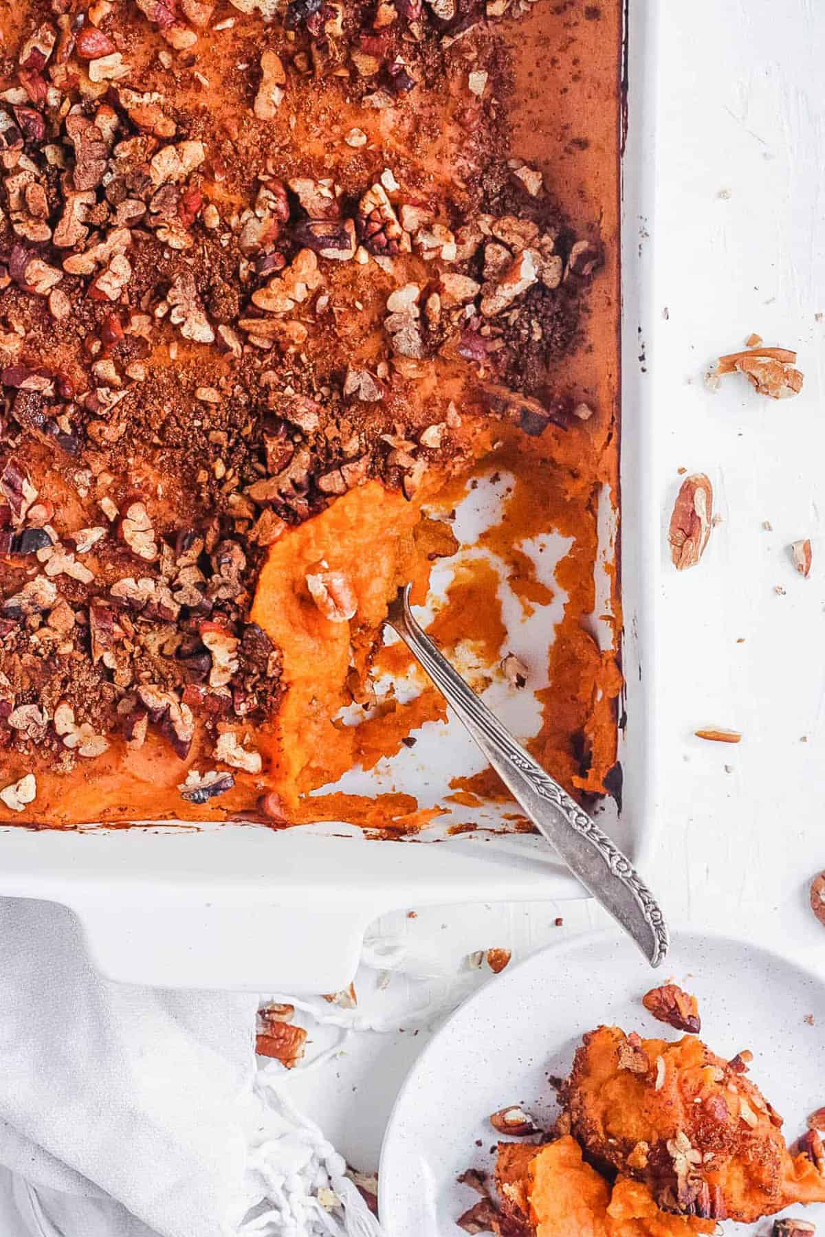 Vegan sweet potato casserole, served in a white baking dish.