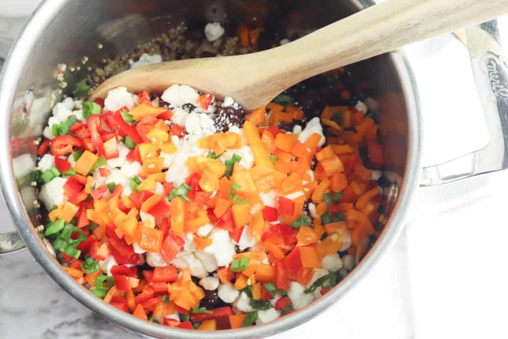 veggies added to a pot on the stovetop