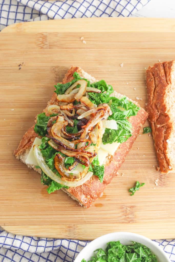 onions and kale on bread