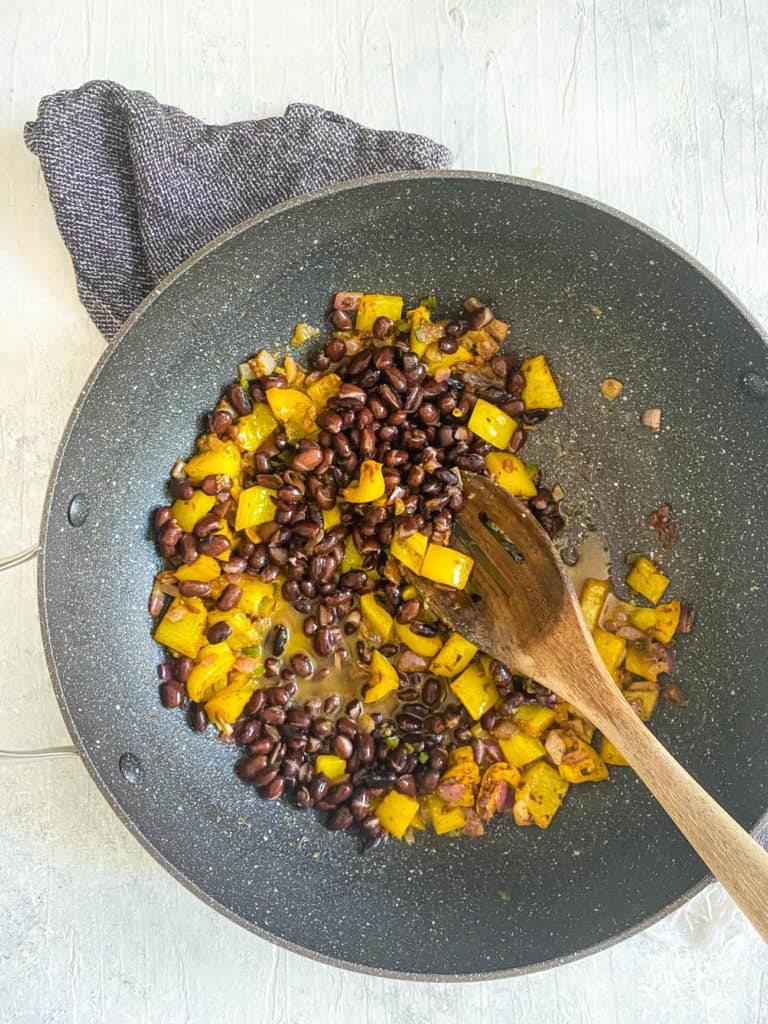 black beans and peppers in a pan