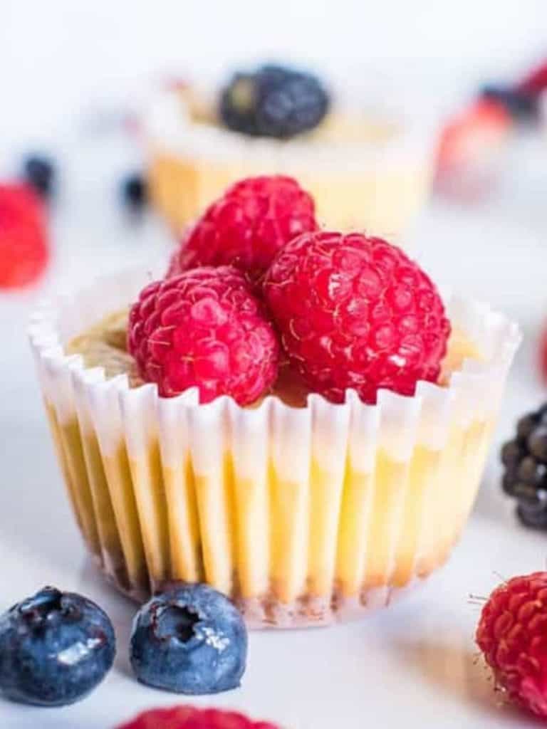 cheesecake bite in muffin cup topped with raspberries - delicious for vegetarian 4th of July recipes
