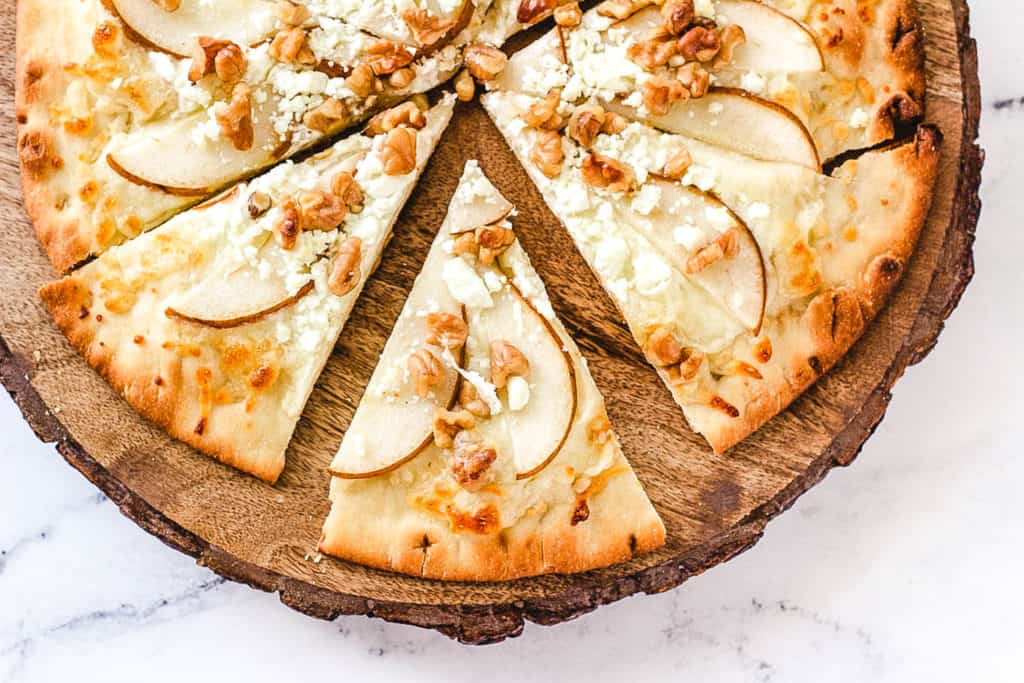 pear gorgonzola pizza served on a wooden cutting board