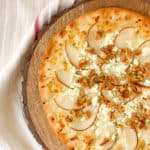 pear gorgonzola pizza served on a wooden cutting board