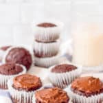 healthy chocolate cupcakes on a blue and white cloth with milk in the background