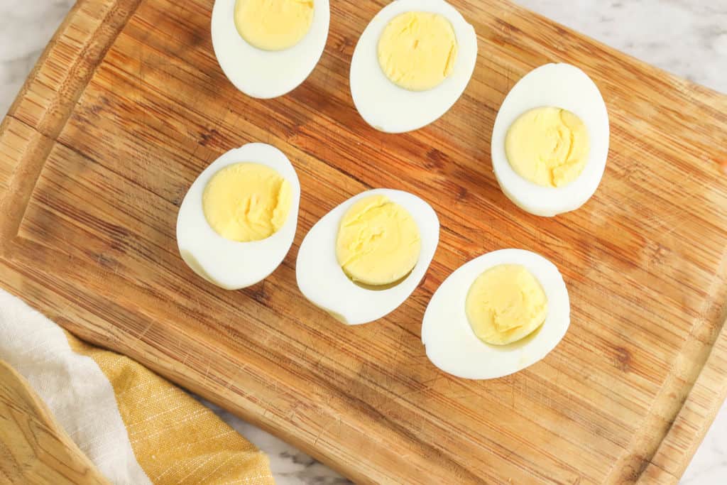 hard boiled eggs on a wooden cutting board