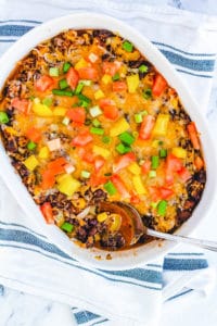 black bean casserole with quinoa and cheese, in a white baking dish