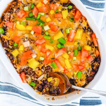 black bean casserole with quinoa and cheese, in a white baking dish