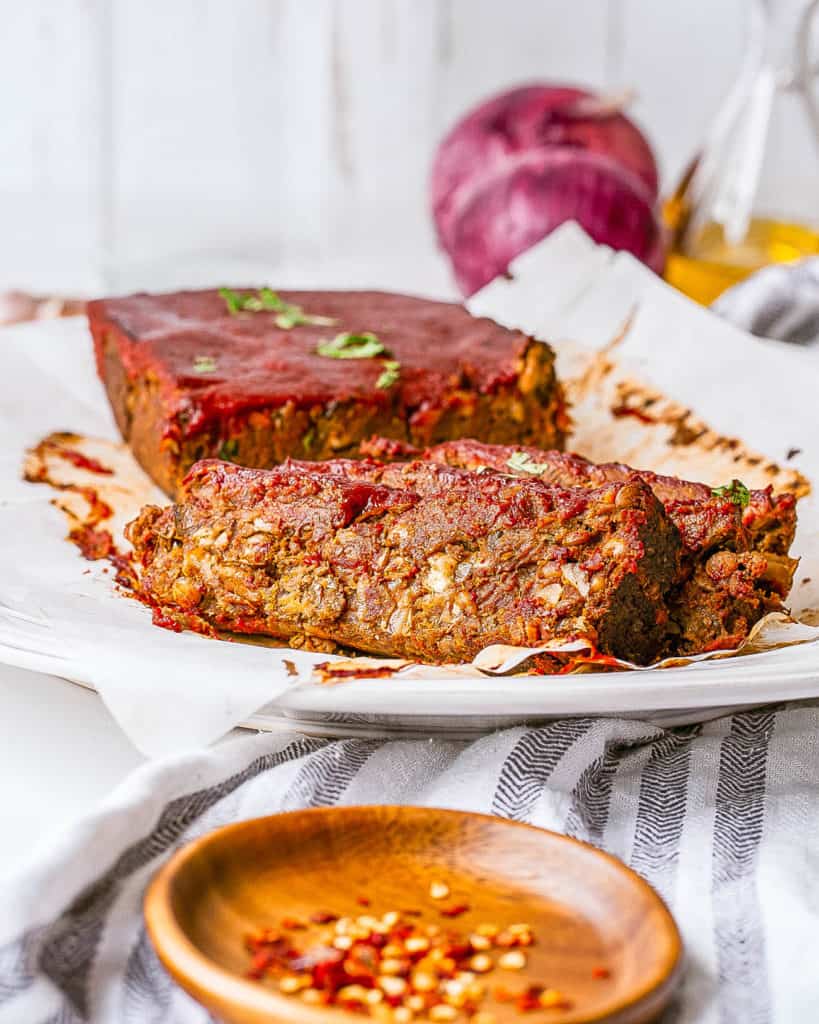 vegan lentil meatloaf / vegan lentil loaf with tomato glaze served on a white plate
