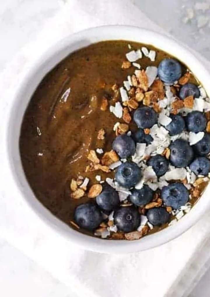 chocolate berry smoothie bowl topped with blueberries coconut and nuts - high protein vegan breakfast