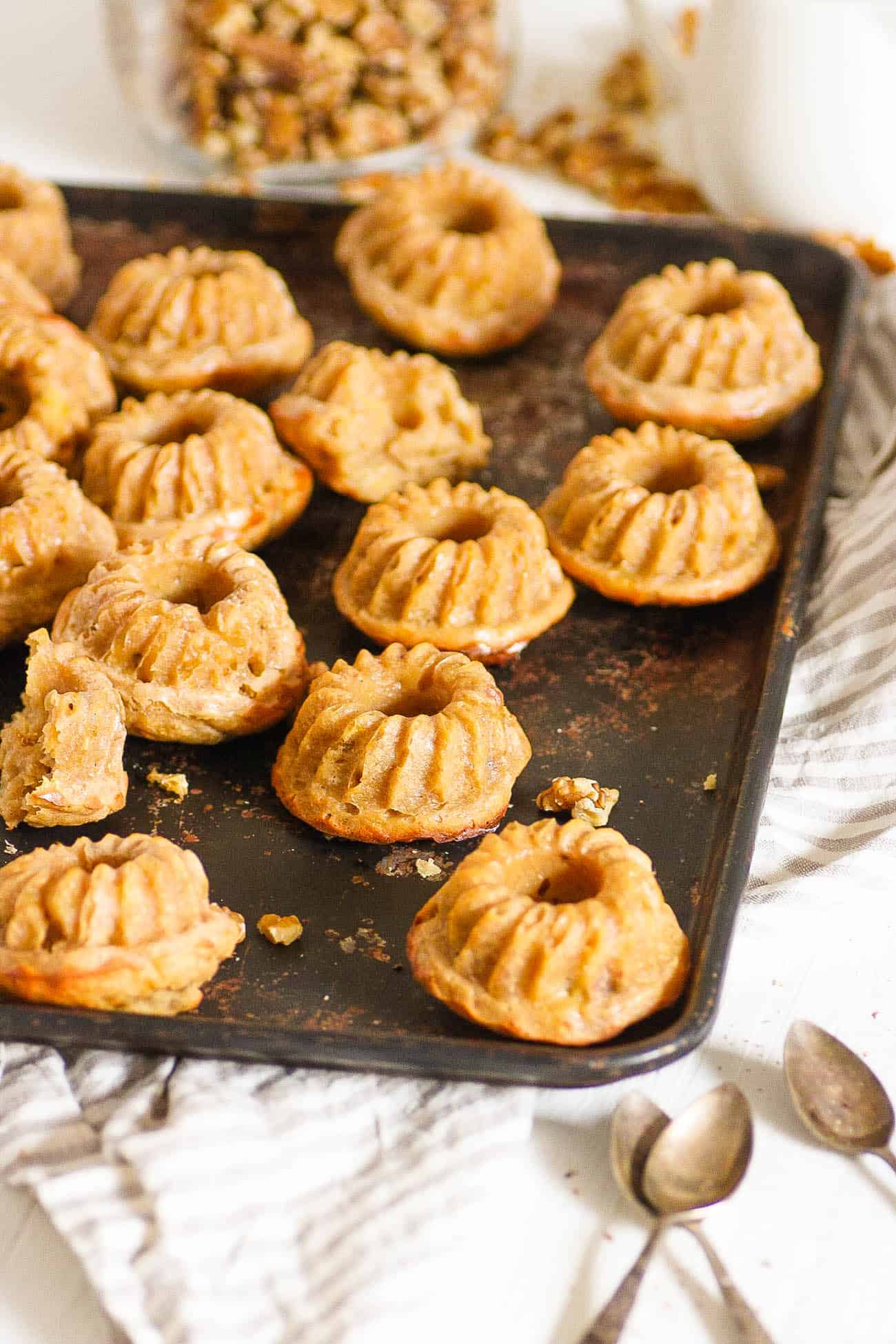 mini bundt cakes with banana and walnuts, served on a baking sheet
