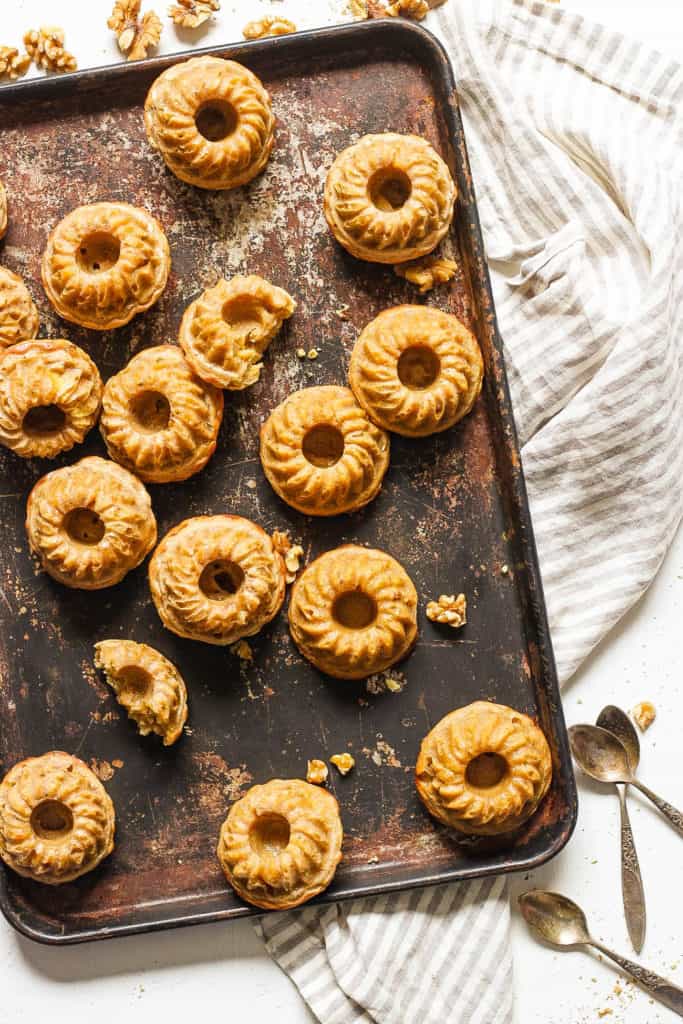 mini bundt cakes with banana and walnuts, served on a baking sheet, top view