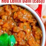 close up of red lentil dahl in red crock