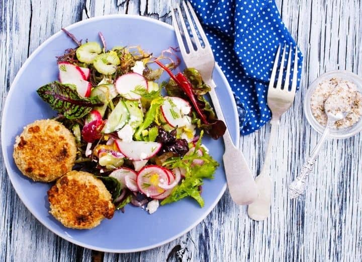 healthy small meals, salad and chickpea cakes on blue plate