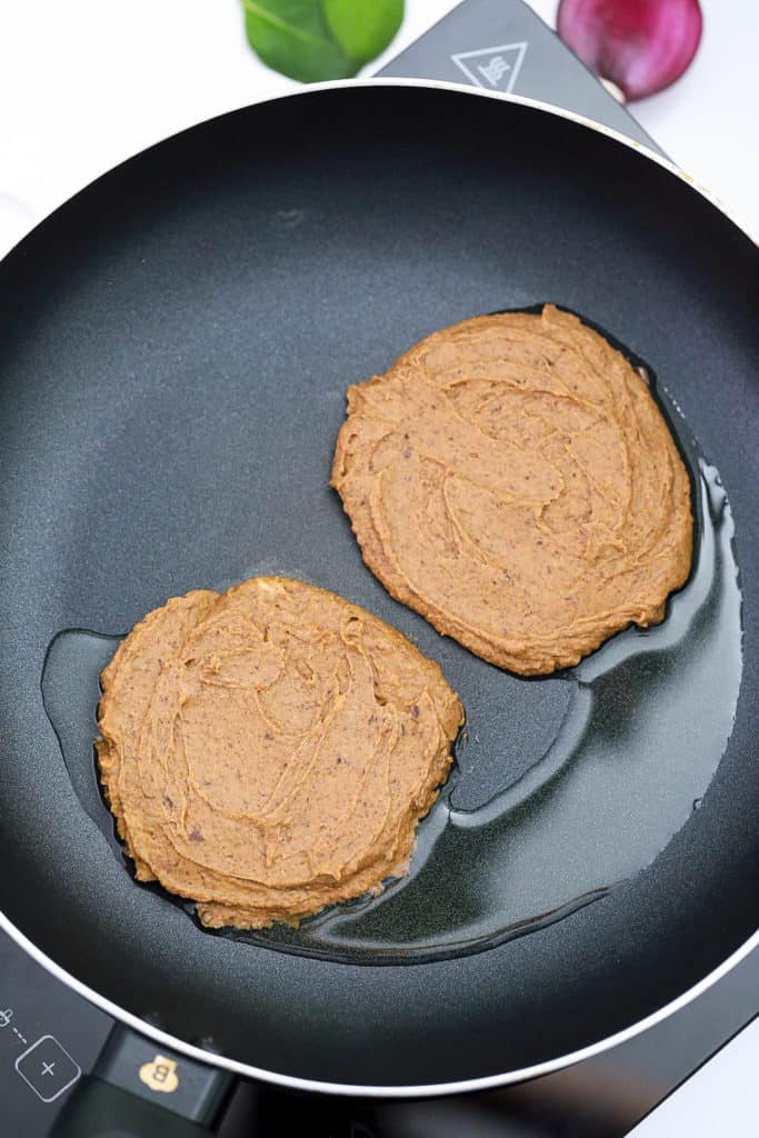 burger patties cooking on the stovetop