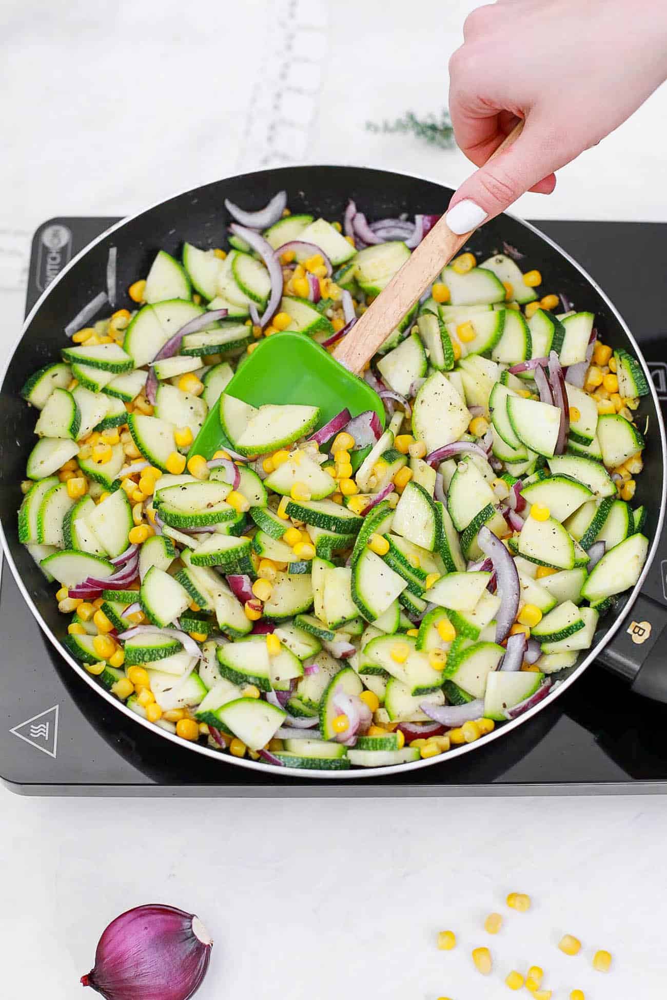 zucchini and veggies cooking on the stovetop