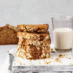 vegan banana bread recipe without butter served on a grey cutting board with a glass of milk
