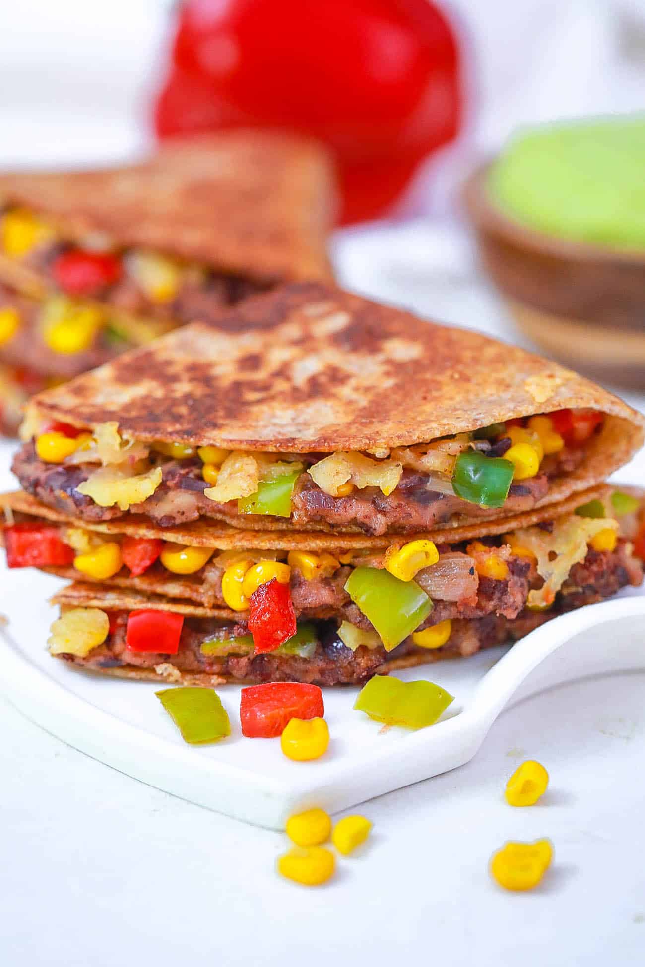 black bean quesadillas with corn and pepper jack cheese on a white plate