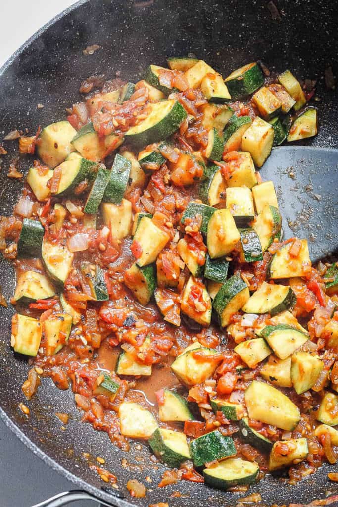 Veggie topping for tostadas sauteeing in a pan on the stove.