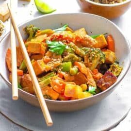 healthy vegetable stir fry recipe served in a white bowl with chopsticks