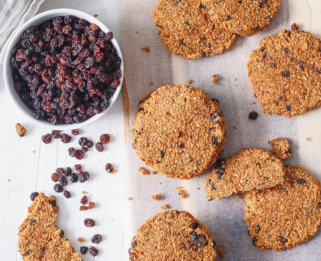 healthy oatmeal raisin cookies stacked on parchment paper