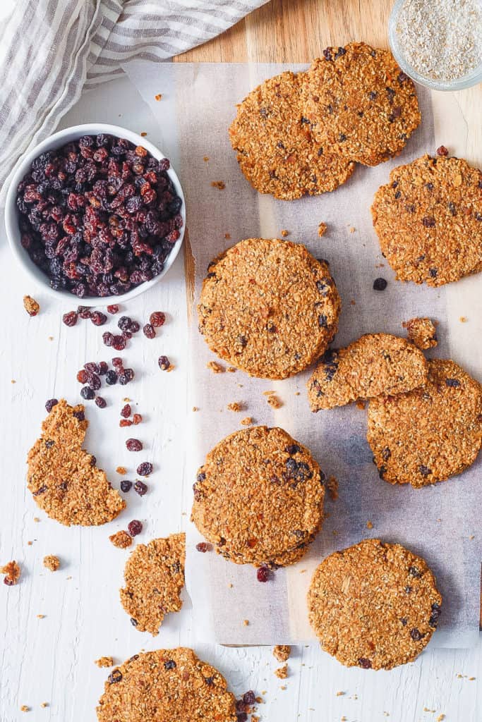 healthy oatmeal raisin cookies stacked on parchment paper