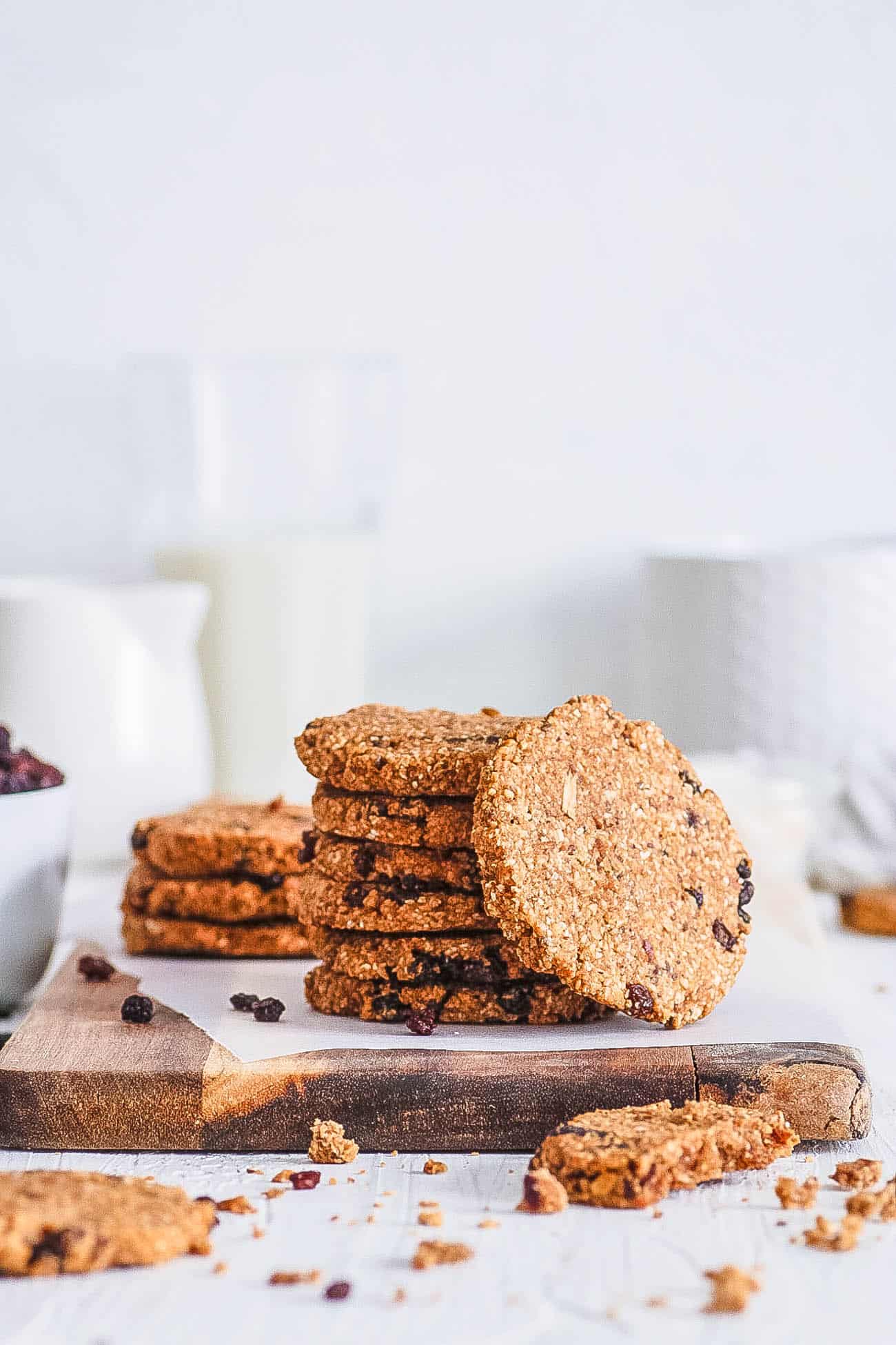 healthy oatmeal raisin cookies stacked on a white plate