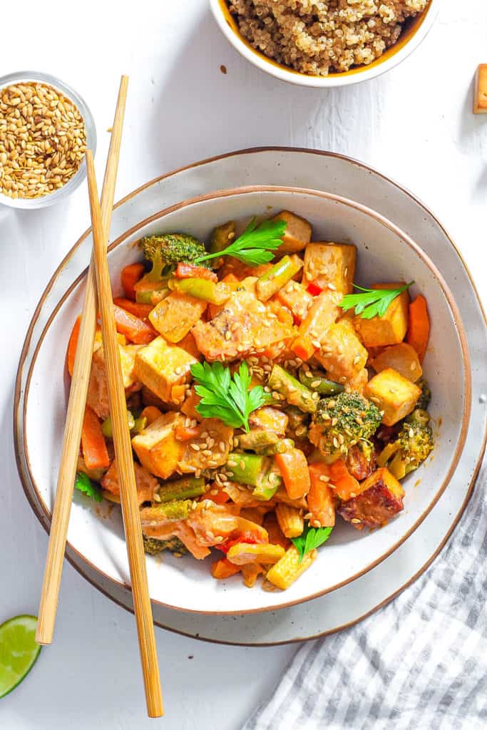 healthy vegetable stir fry recipe served in a white bowl with chopsticks