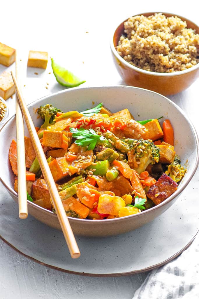 healthy vegetable stir fry recipe served in a white bowl with chopsticks