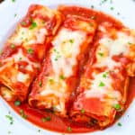 pasta rolls with pomodoro sauce on a white plate