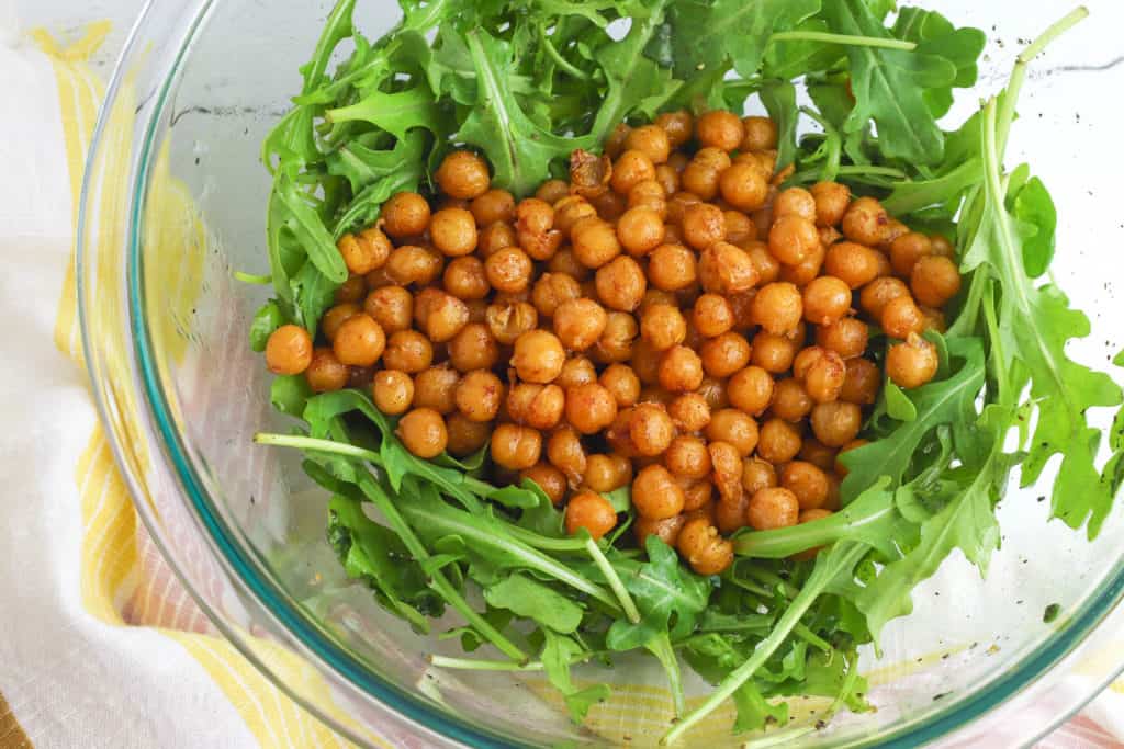 chickpeas and arugula in a bowl