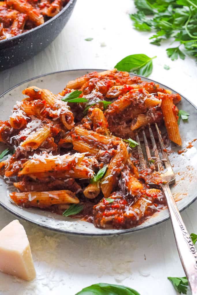 red lentil pasta served on a white plate with superfood marinara sauce