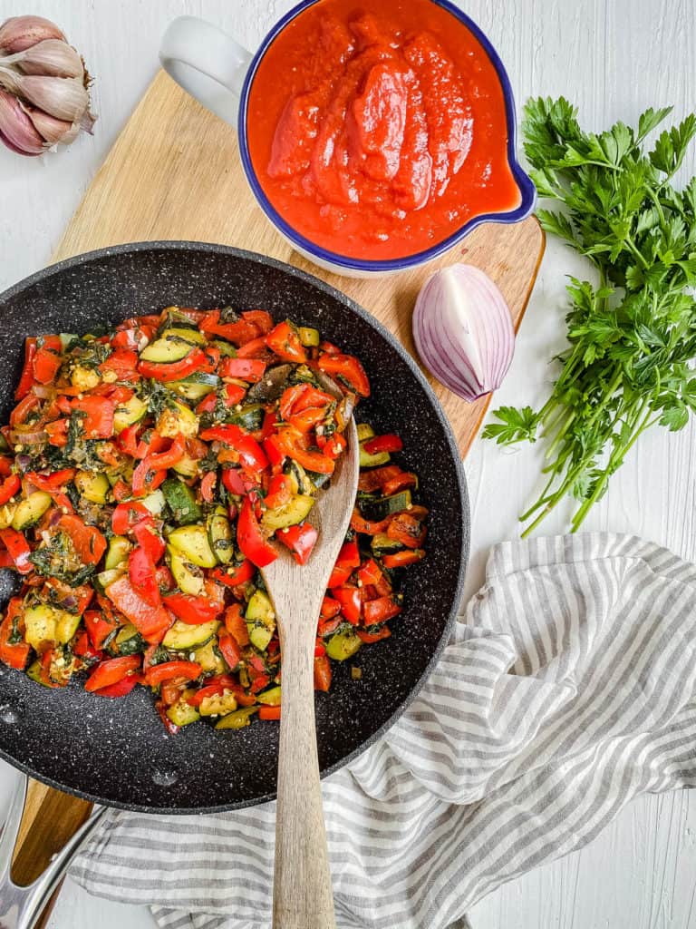 veggies for sauce cooking in a pan