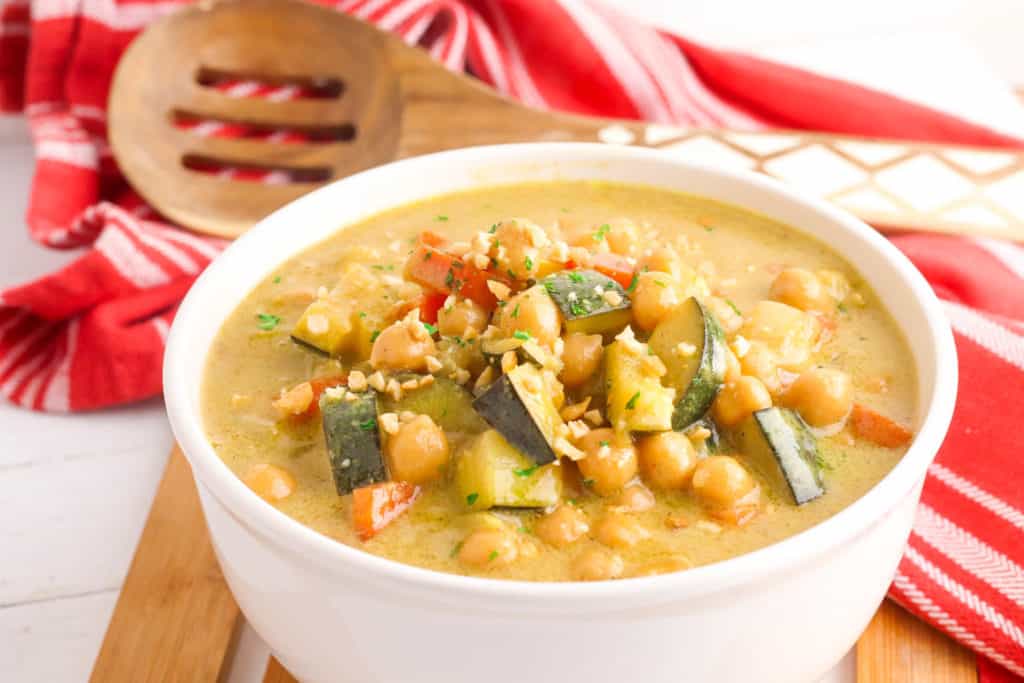 thai peanut curry with chickpeas, served in a white bowl