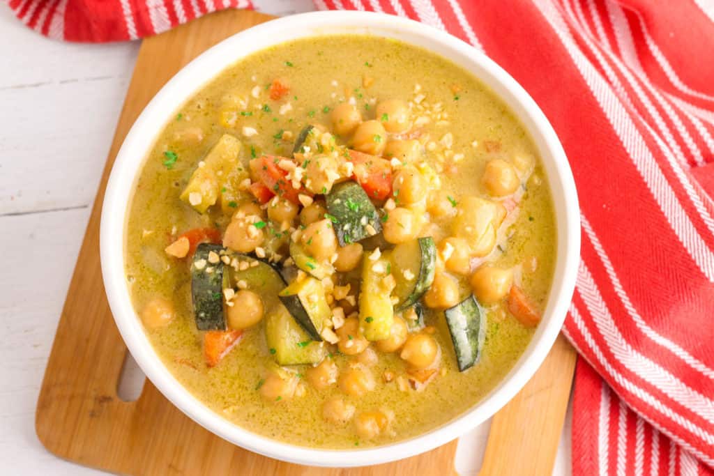 thai peanut curry with chickpeas, served in a white bowl
