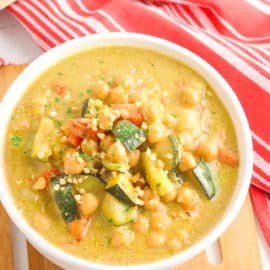thai peanut curry with chickpeas, served in a white bowl